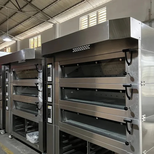 R&M artisan bread ovens in factory — multiple deck oven units in production and quality inspection