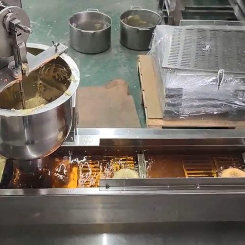 Automatic donut machine RMT-101 in operation frying ring donuts commercial donut fryer