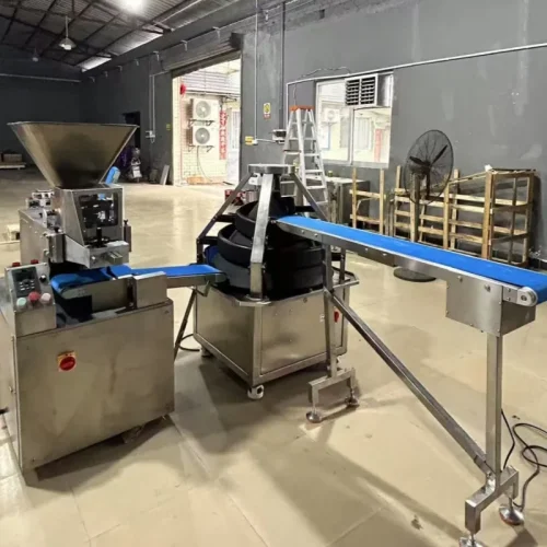 R&M continuous dough divider and conical rounder connected by conveyor in factory