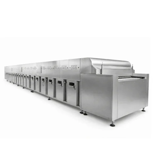 Industrial tunnel oven exit discharge section — finished products exit to cooling conveyor