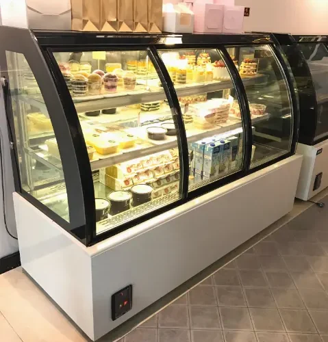 R&M RMQKY pastry display case installed in dessert shop three tier refrigerated interior
