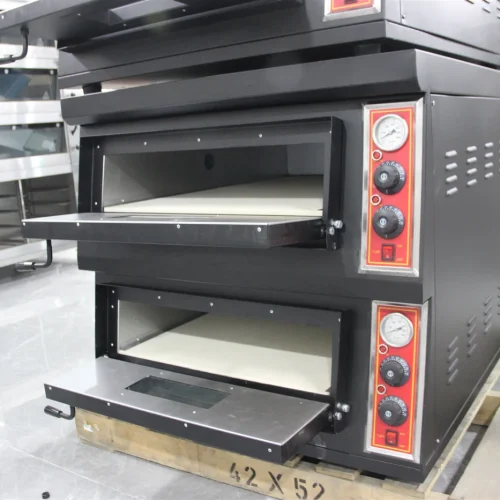 Double deck pizza oven at factory with both doors open showing stone decks