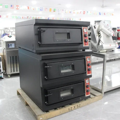 Pizza deck ovens stacked in R&M showroom — three-deck configuration displayed on pallet