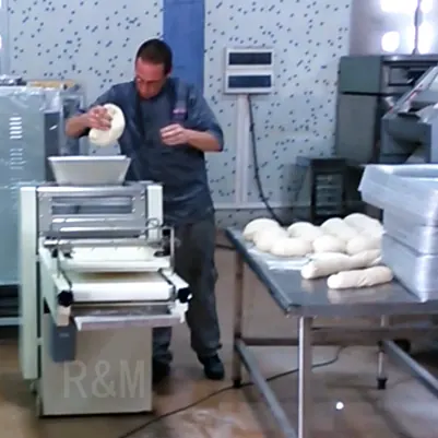 R&M RMZ-380 toast moulder feeding operation — baker placing dough ball into hopper