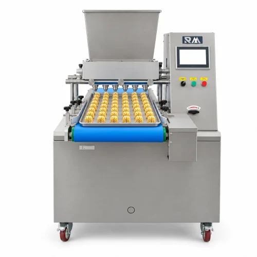 Front view of the Jenny cookies machine with a row of nozzles depositing star-shaped cookies