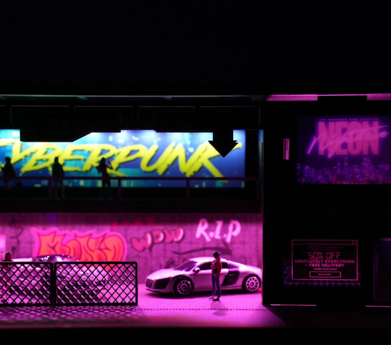 Full scene presentation of cyberpunk garage diorama with die-cast model placement